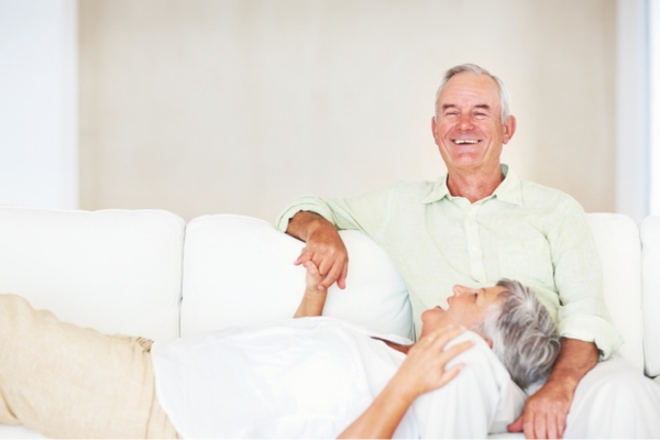 elderly couple lounging on the couch depicting reliable whole house generator