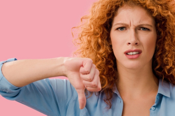 woman doing a disapproving face and thumbs down depicting no to DIY for electrical air conditioner issues