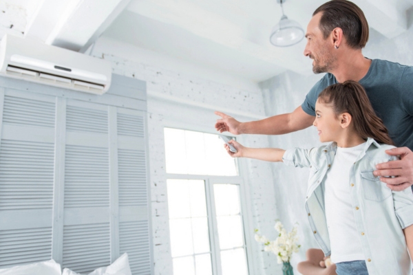 dad teaching daughter proper use of ductless air conditioner