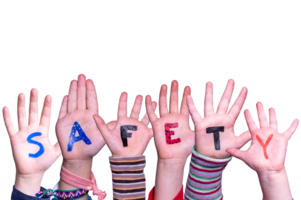 safety word painted on hands of children depicting oil tank design safety 