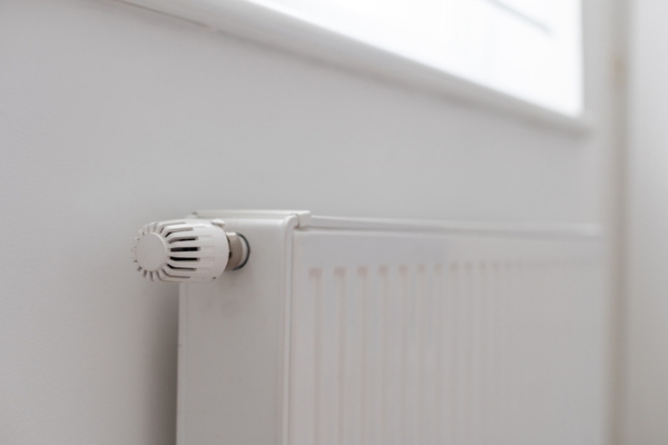 side view of a home heating radiator and control knob