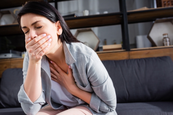 woman experiencing nausea depicting carbon monoxide exposure