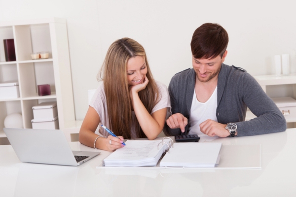 couple assessing fuel expenses to decide between will call or automatic oil delivery